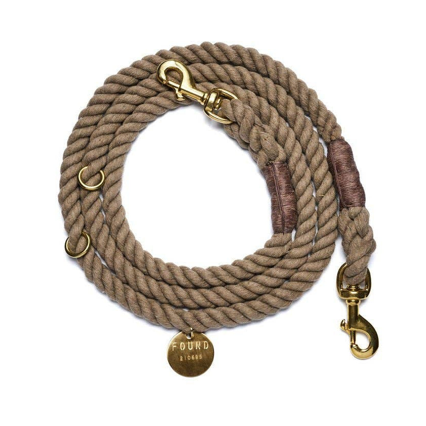 Beige rope dog leash with gold hardware and a 'FOUND' tag on a white background