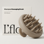 Shampoo massaging brush with 'L'flo' branding on a light background