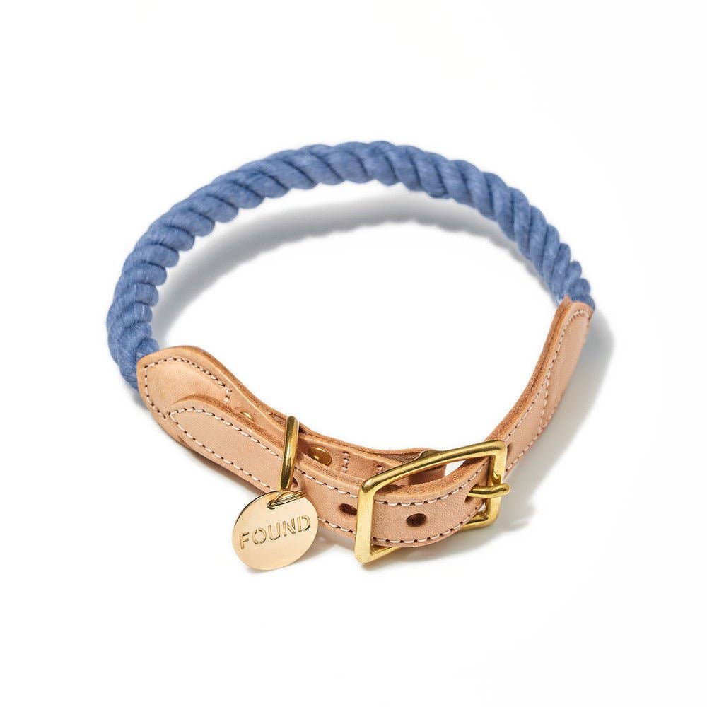 Dog collar with blue rope, beige leather strap, and gold clasp on a white background