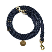 Navy blue rope dog leash with gold hardware on a white background