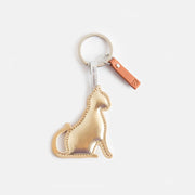 Gold cat keyring with silver-tone hardware and tan tab from Bell & Beau.