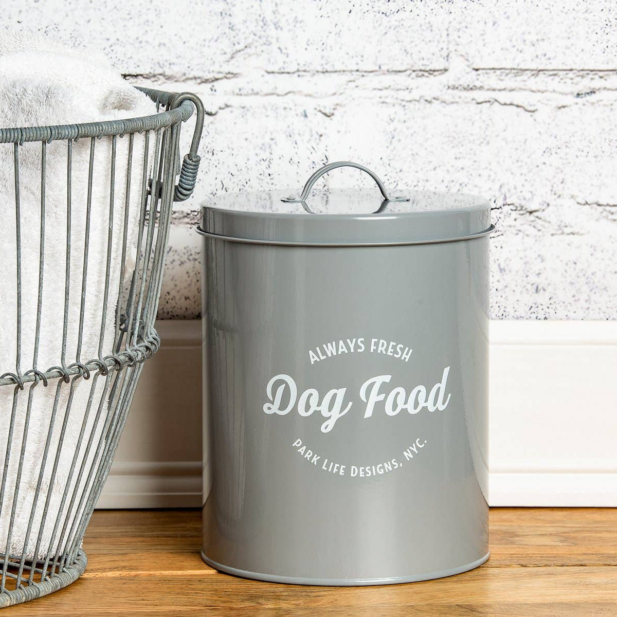 Stylish grey carbon steel dog treat storage canister with airtight silicone seal.