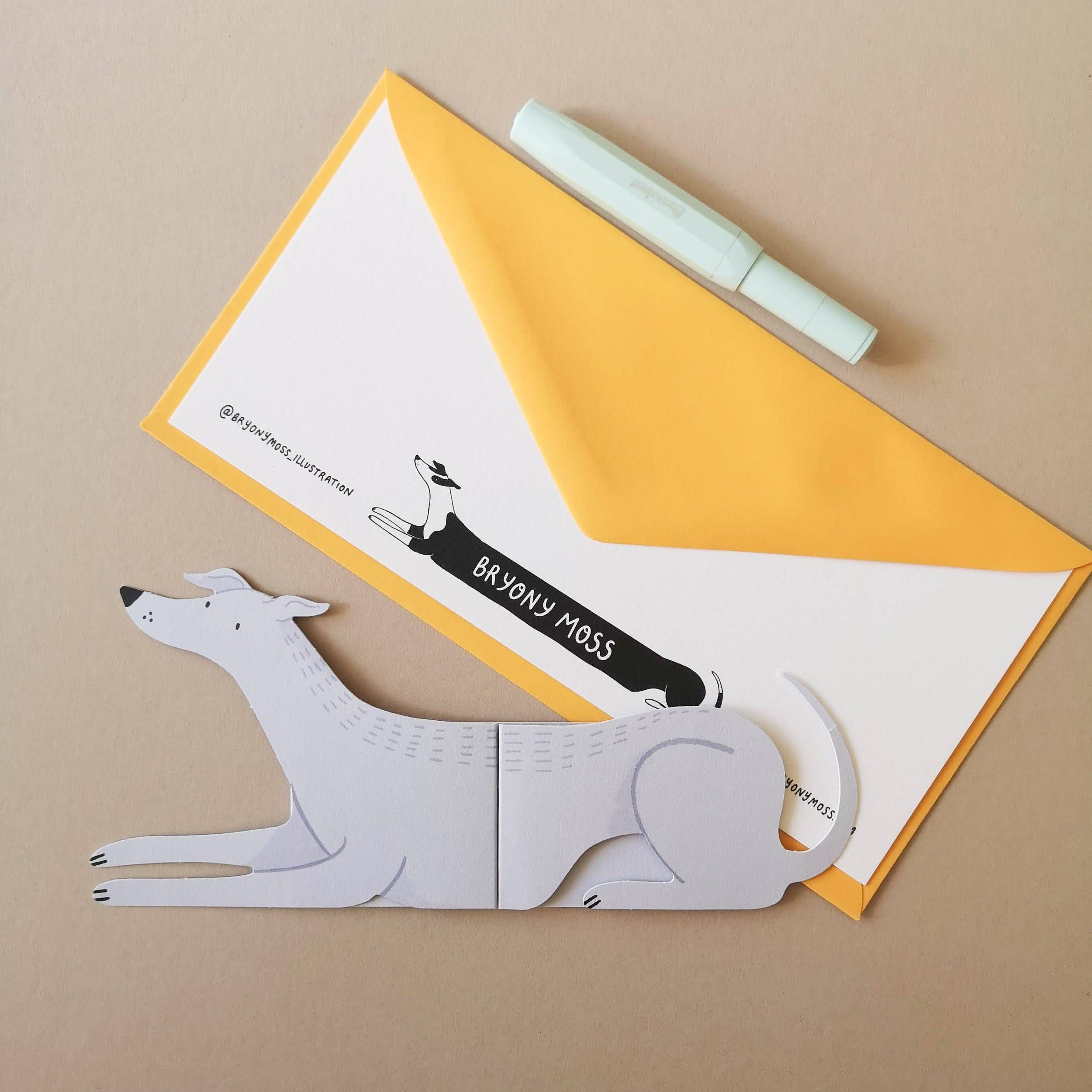 Dog-shaped paper cutout on a yellow envelope with a brand logo.