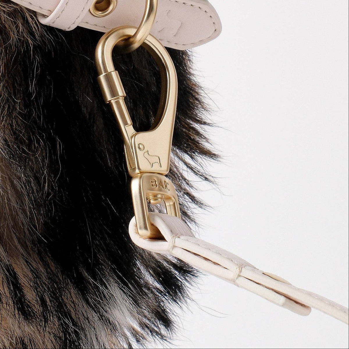 Soft cream vegan leather dog lead with gold clasps by Barc London.