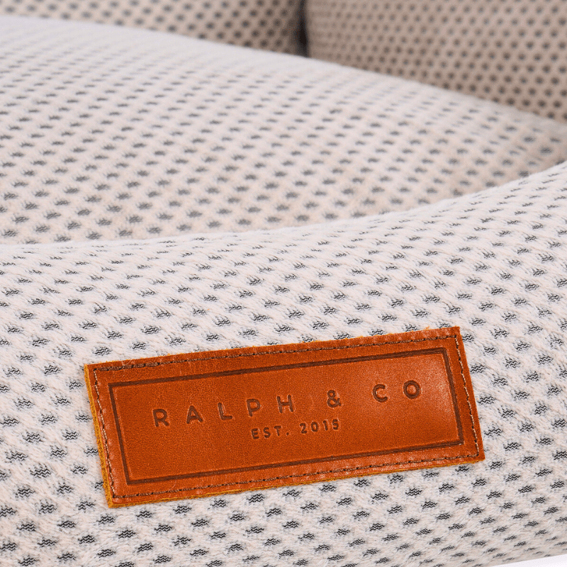 Luxury beige memory foam dog bed by Ralph & Co with deep cushioned bolster walls