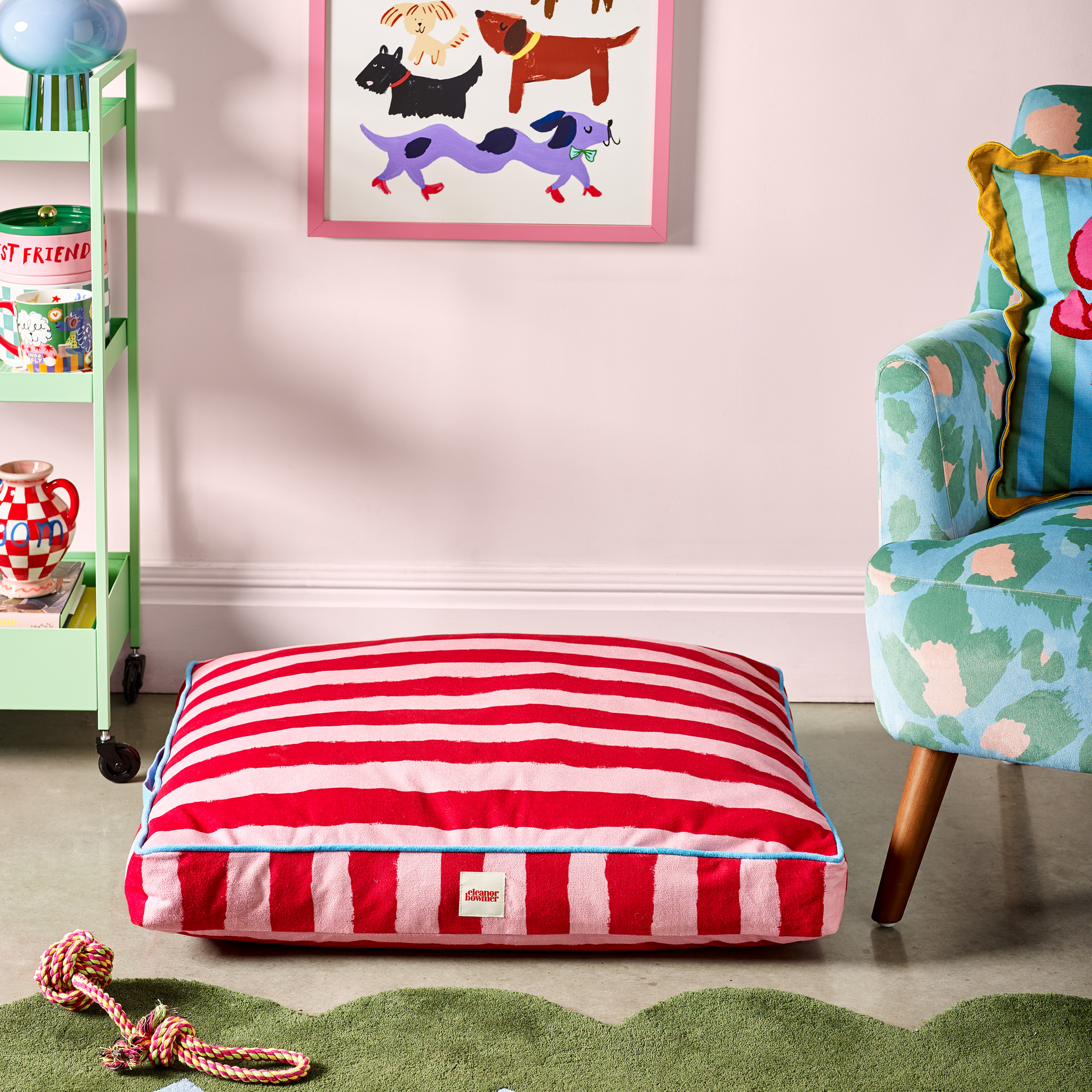 Soft padded flat dog bed with colourful striped pattern.