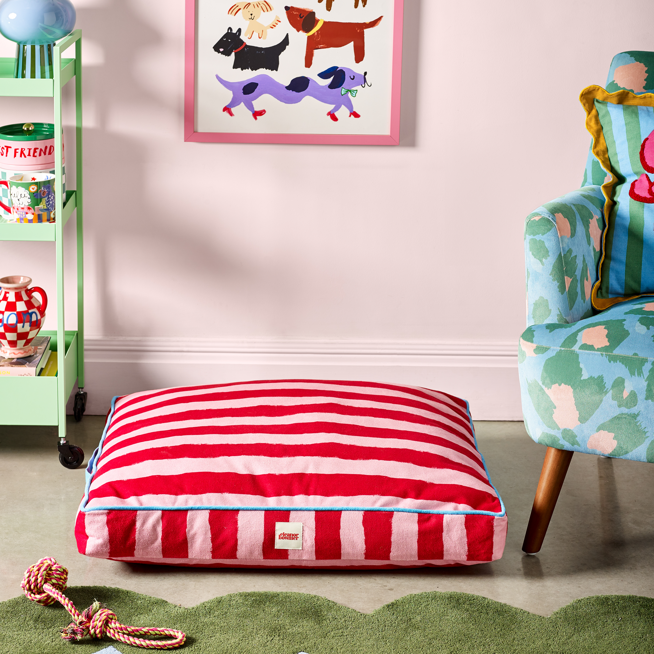 Soft padded flat dog bed with colourful striped pattern.