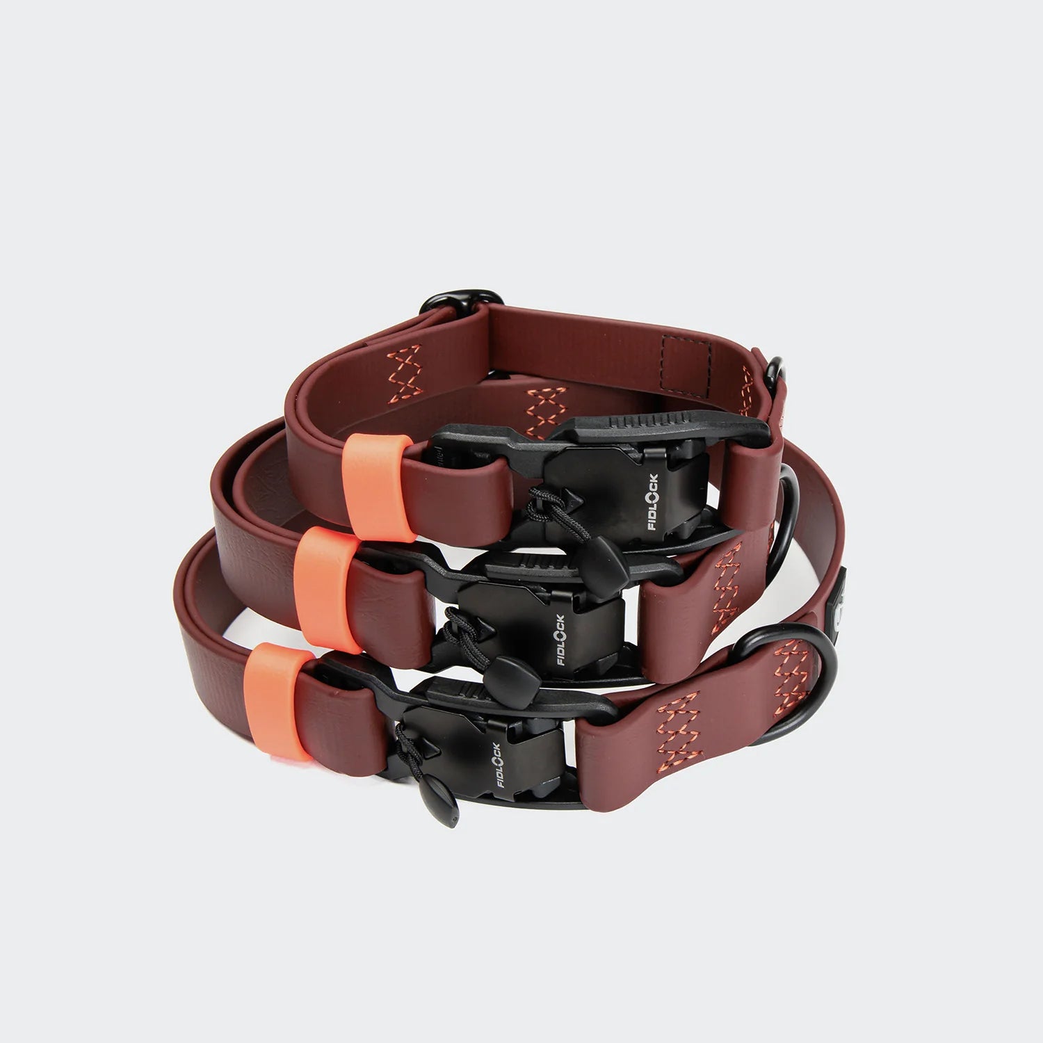 Brown and black dog collar with orange accents on a light gray background