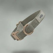 Gray dog collar with a rose gold buckle on a gray background