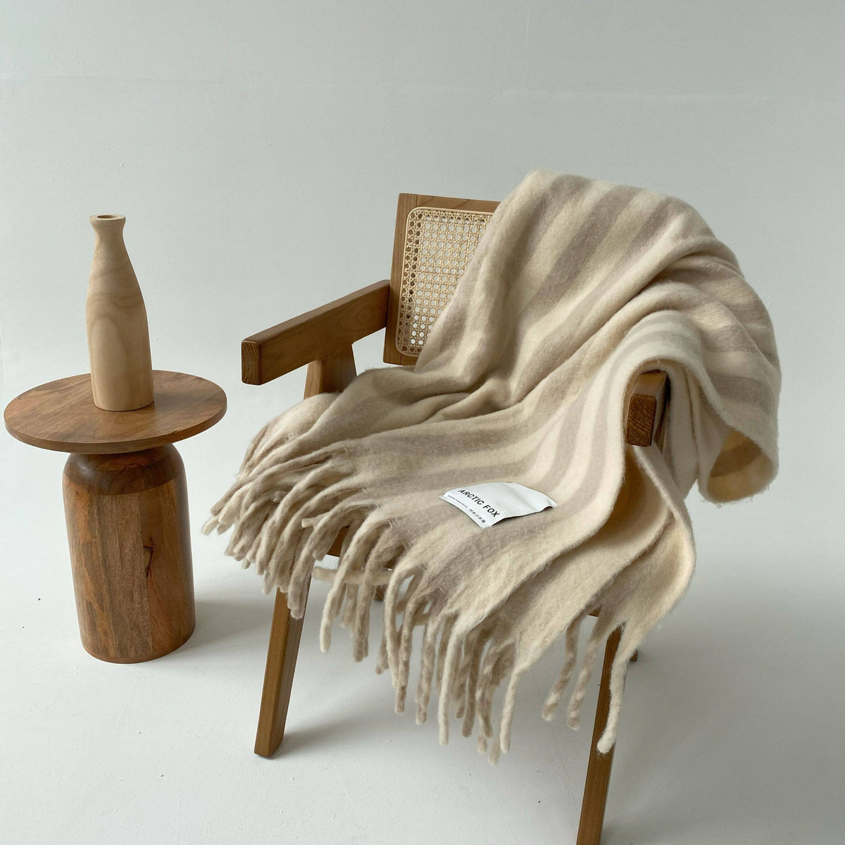 Luxury striped throw blanket made with merino wool and recycled polyester.