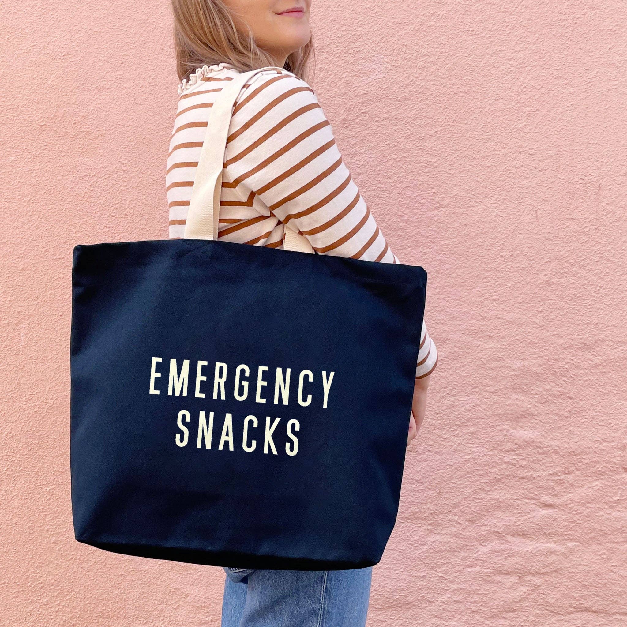 Midnight blue 15oz canvas tote bag printed with Emergency Snacks slogan.