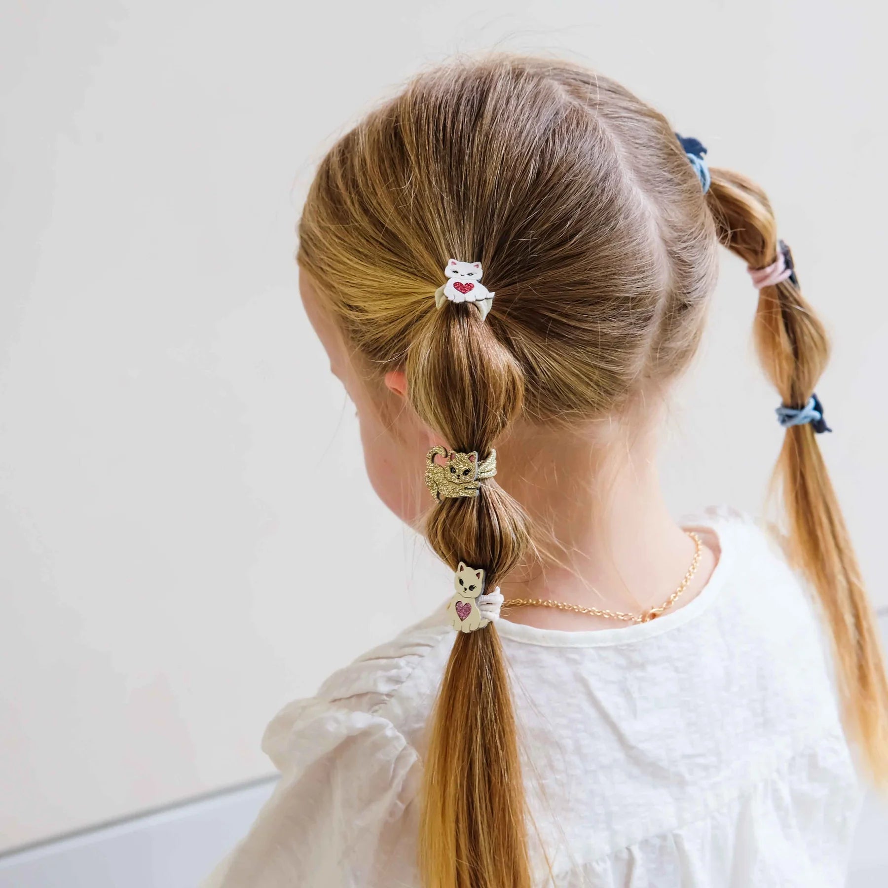 Set of six Mimi & Lula kitten hair ties in pink blue gold and neutral colours