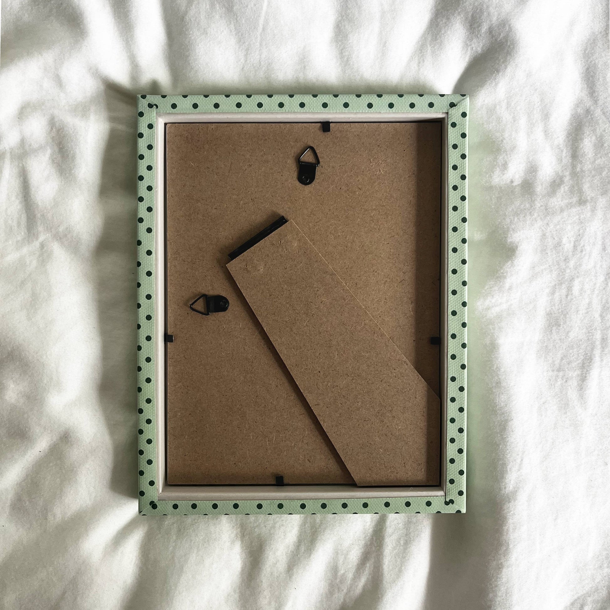 Contemporary cotton fabric-wrapped picture frame in mint green and emerald.