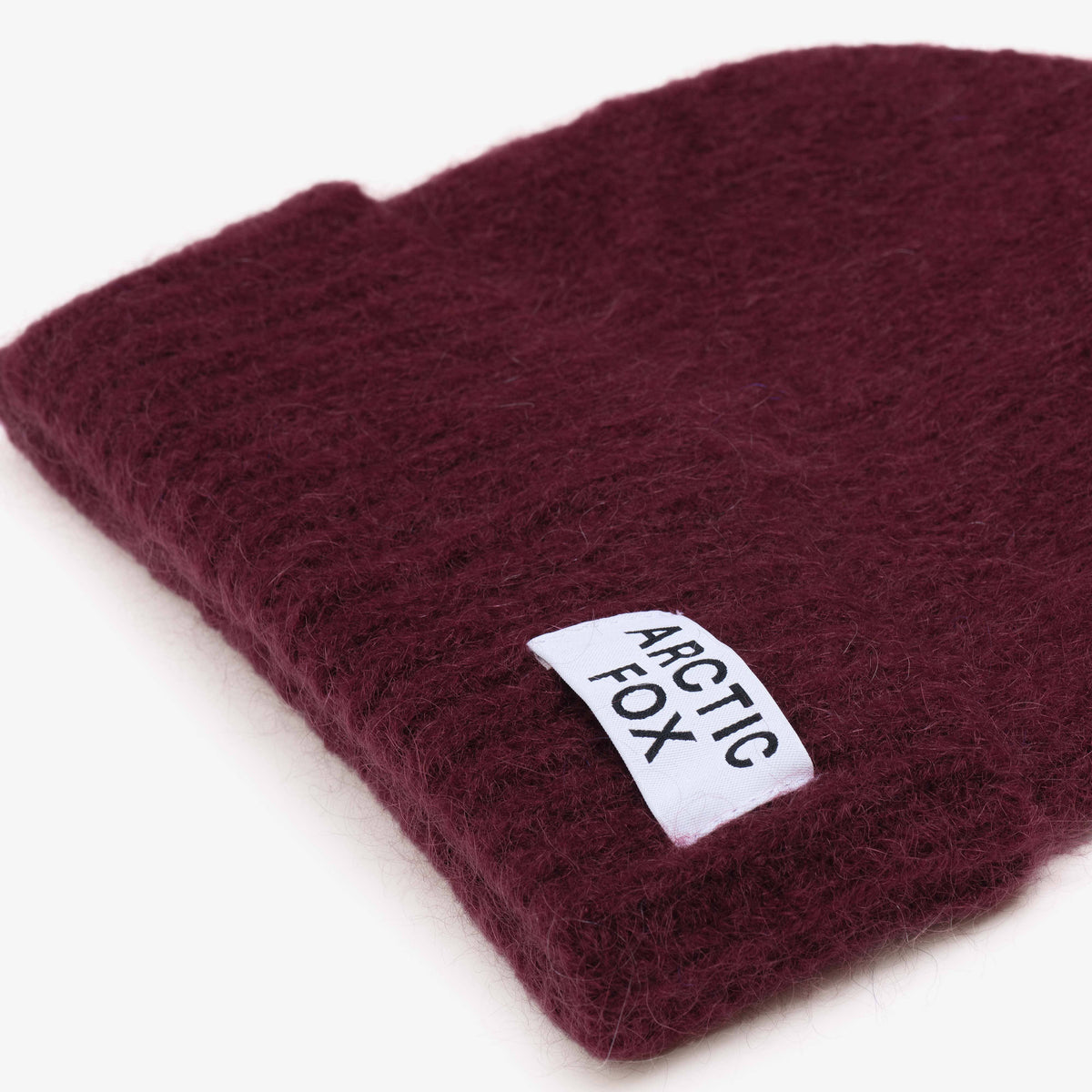 Deep burgundy luxury winter beanie for cold-weather walks and everyday wear.