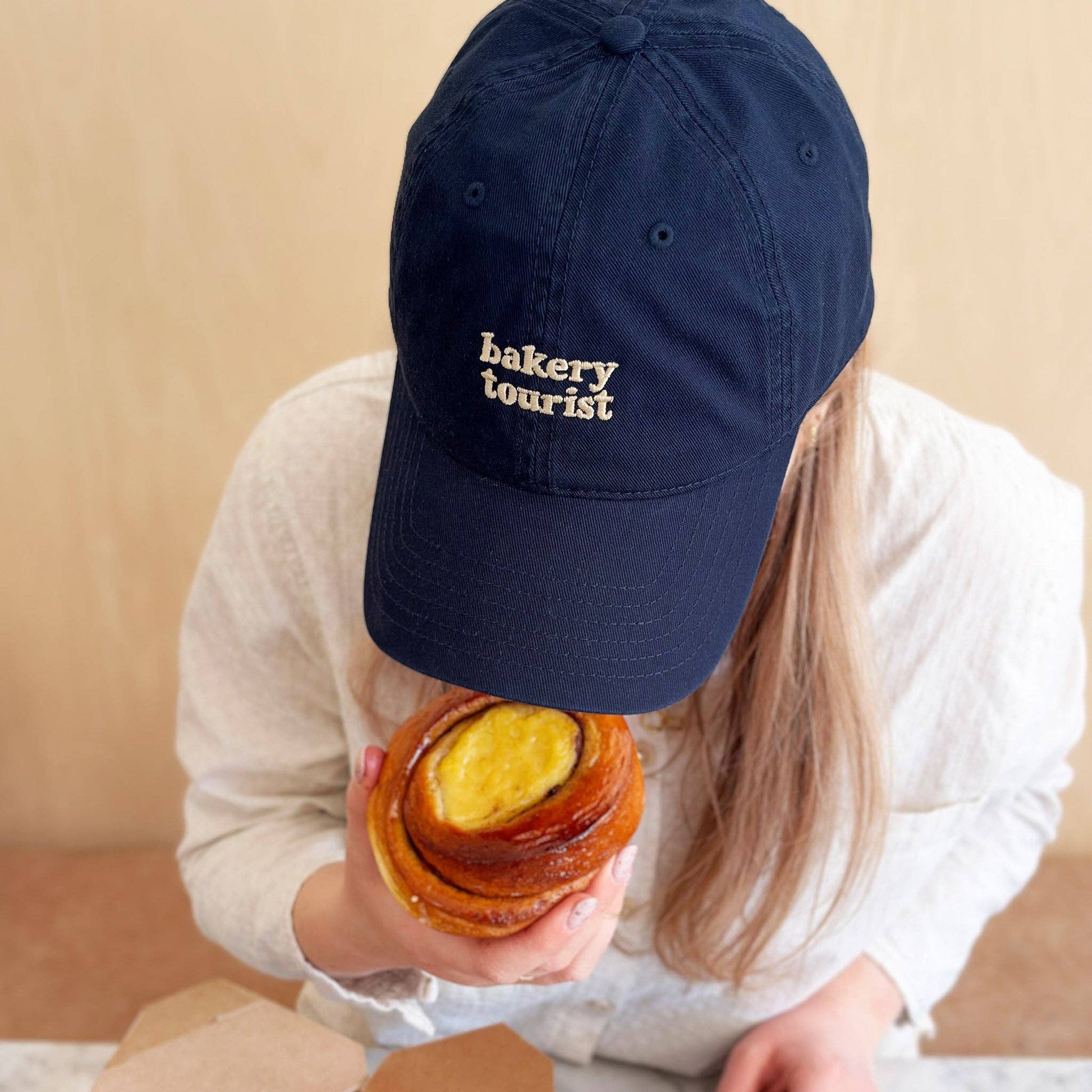 Navy blue cotton Bakery Tourist baseball cap with embroidered slogan.