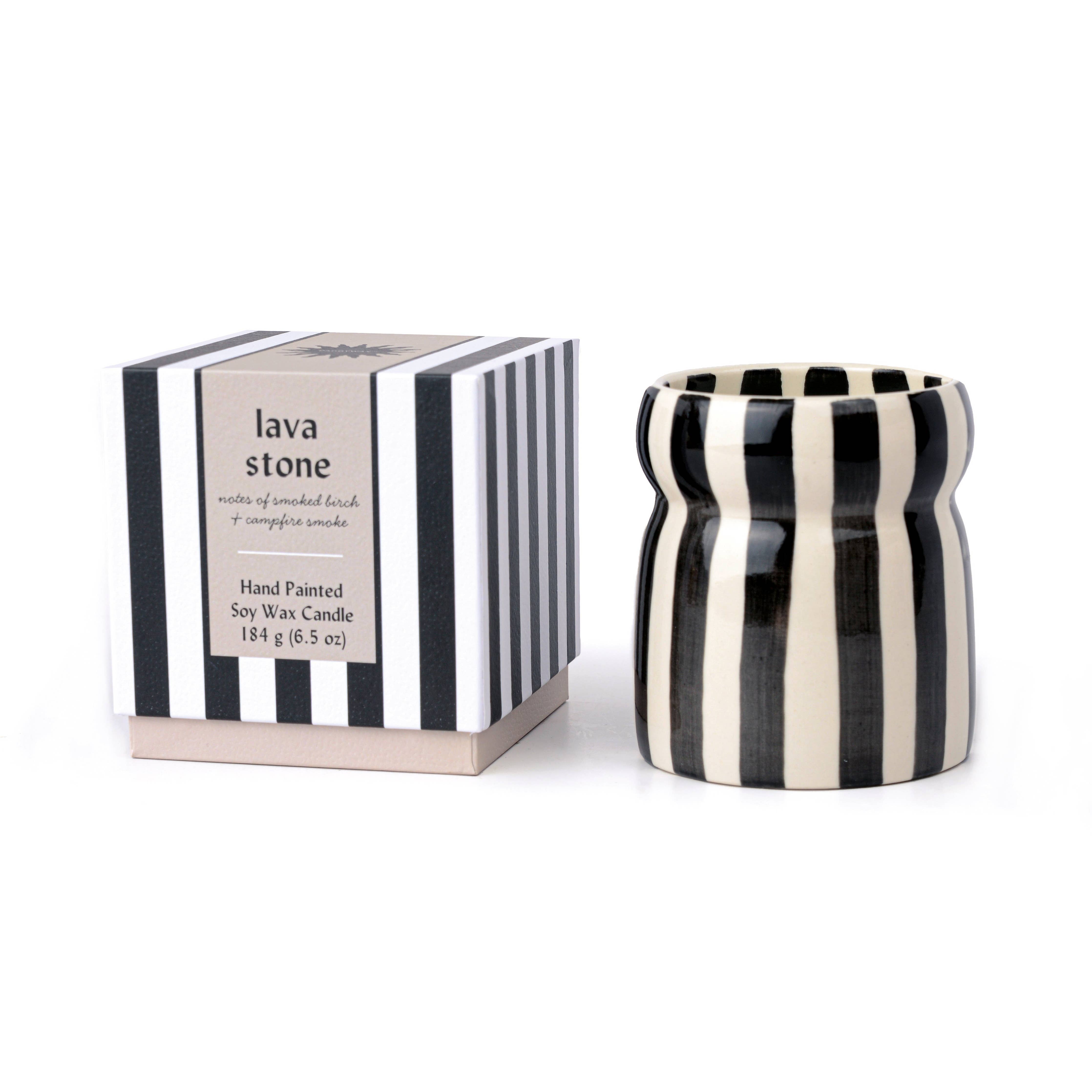 Paddywax Cabana Lava Stone candle in hand-painted black striped ceramic vessel.