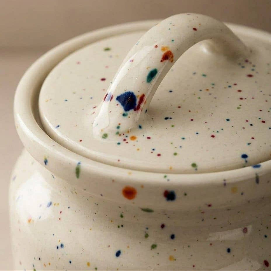 Decorative white stoneware storage jar for kitchen essentials