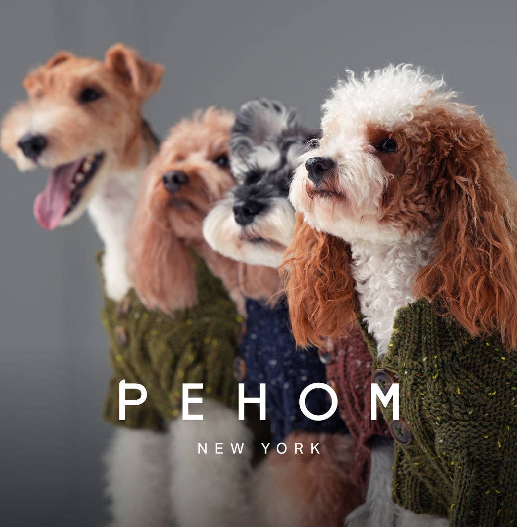 Four dogs wearing knitted sweaters with 'PEHOM New York' branding.