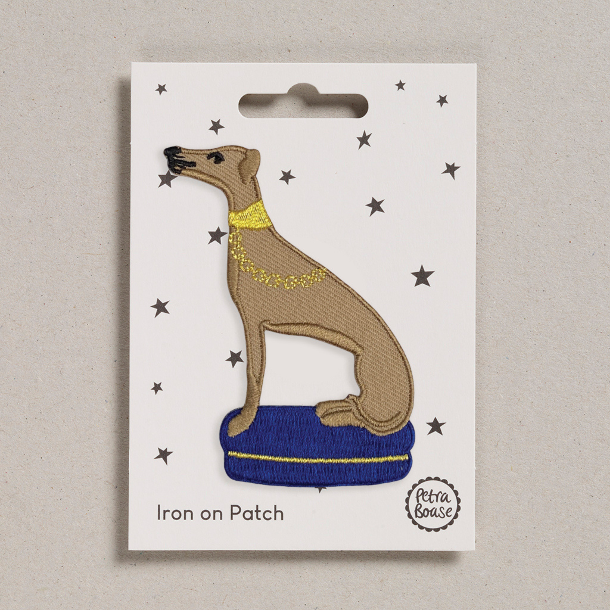 Petra Boase embroidered Whippet iron-on patch on soft fawn fabric.