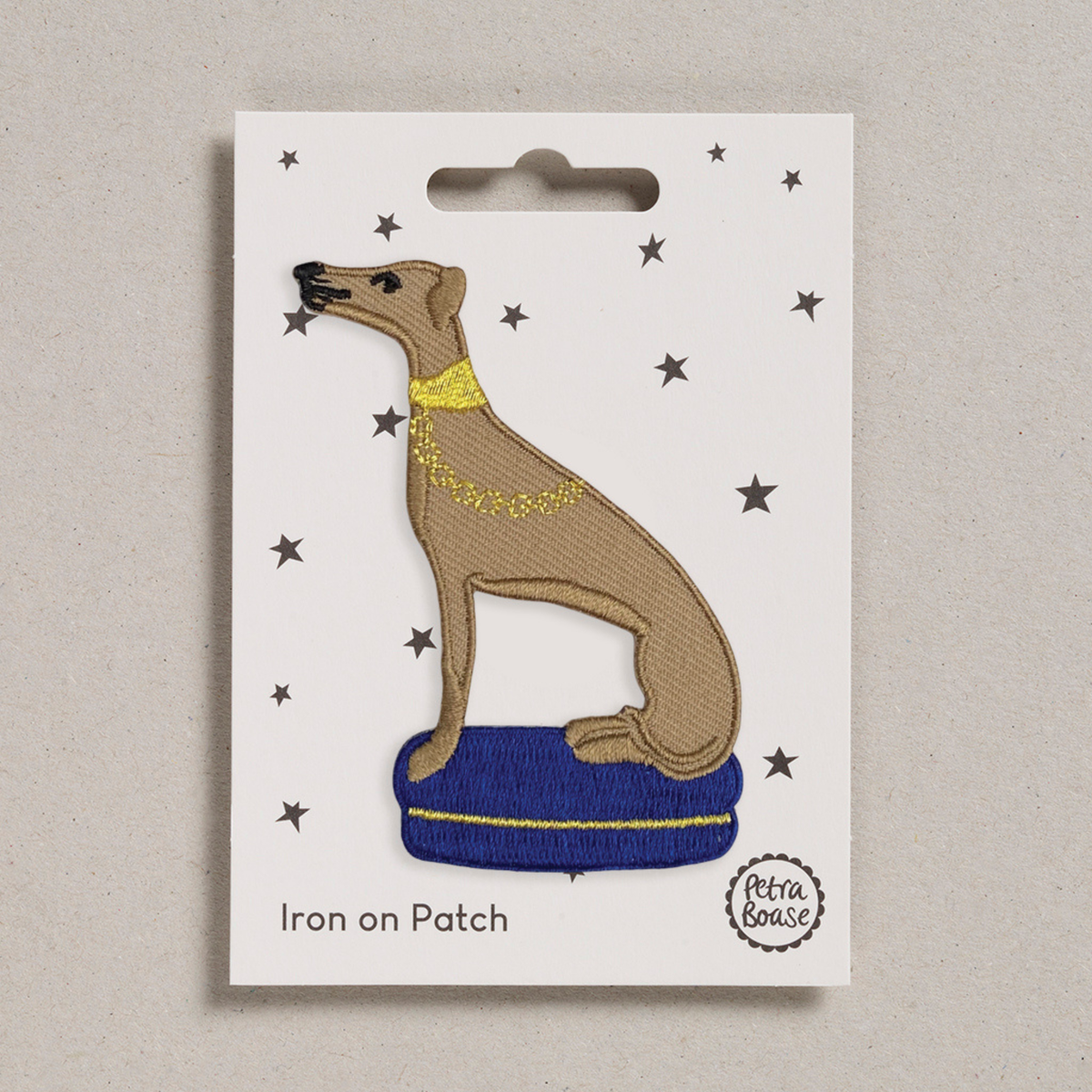 Petra Boase embroidered Whippet iron-on patch on soft fawn fabric.