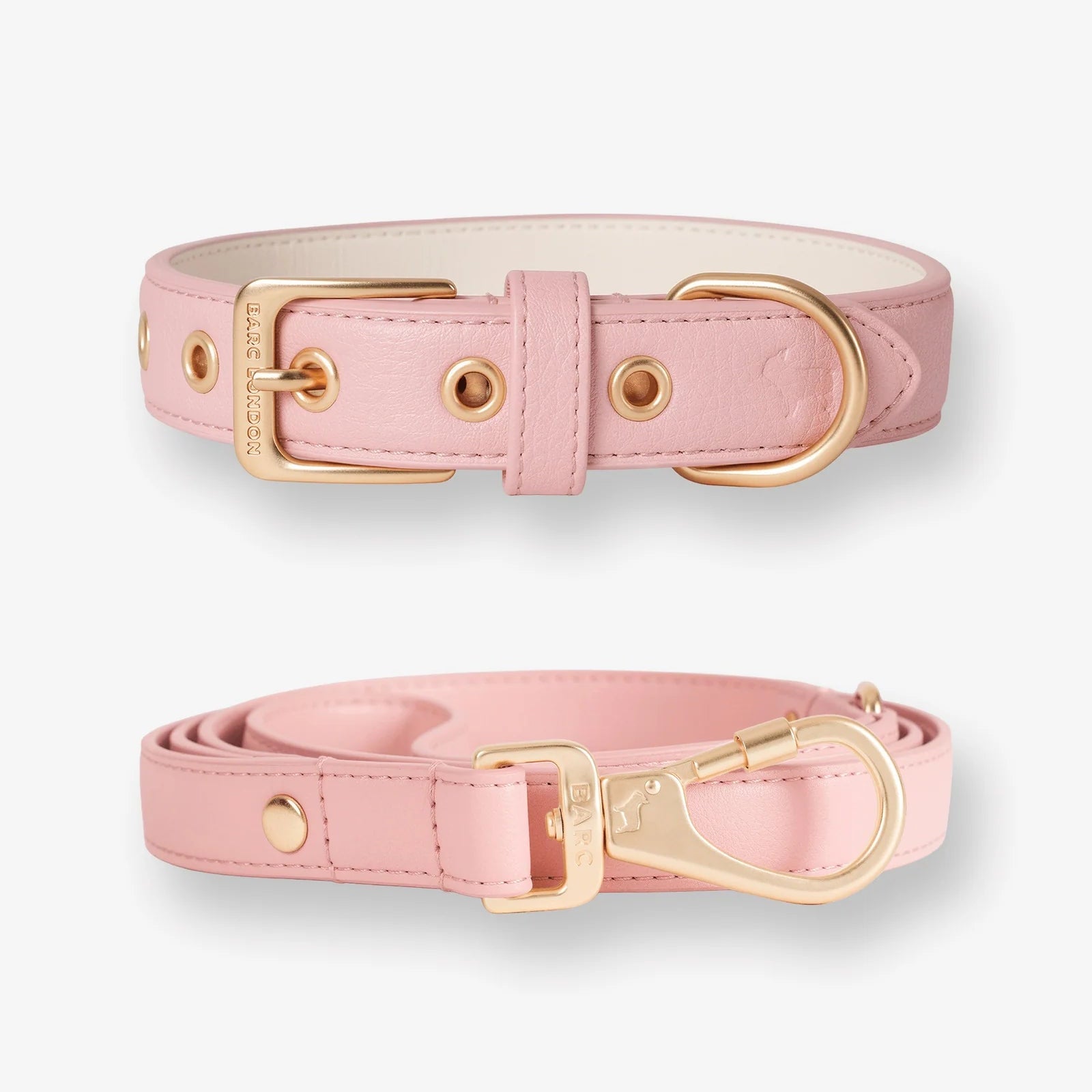 Pink dog collar and leash set with gold hardware on a white background