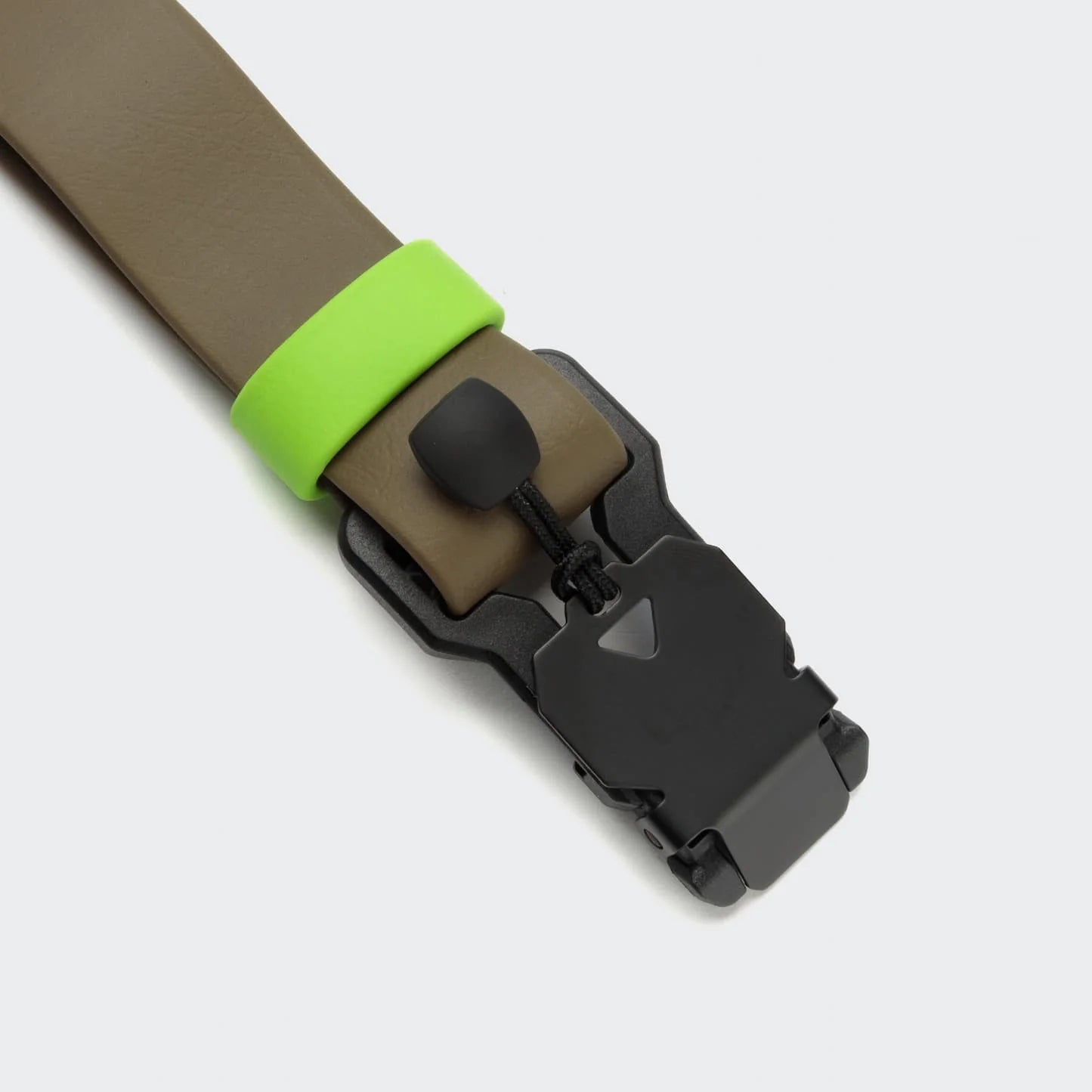 Brown belt with a green buckle and black buckle on a light gray background