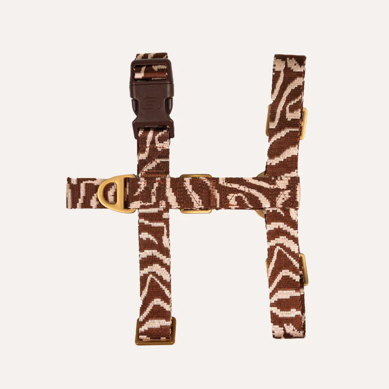 Zebra-patterned dog harness on a white background