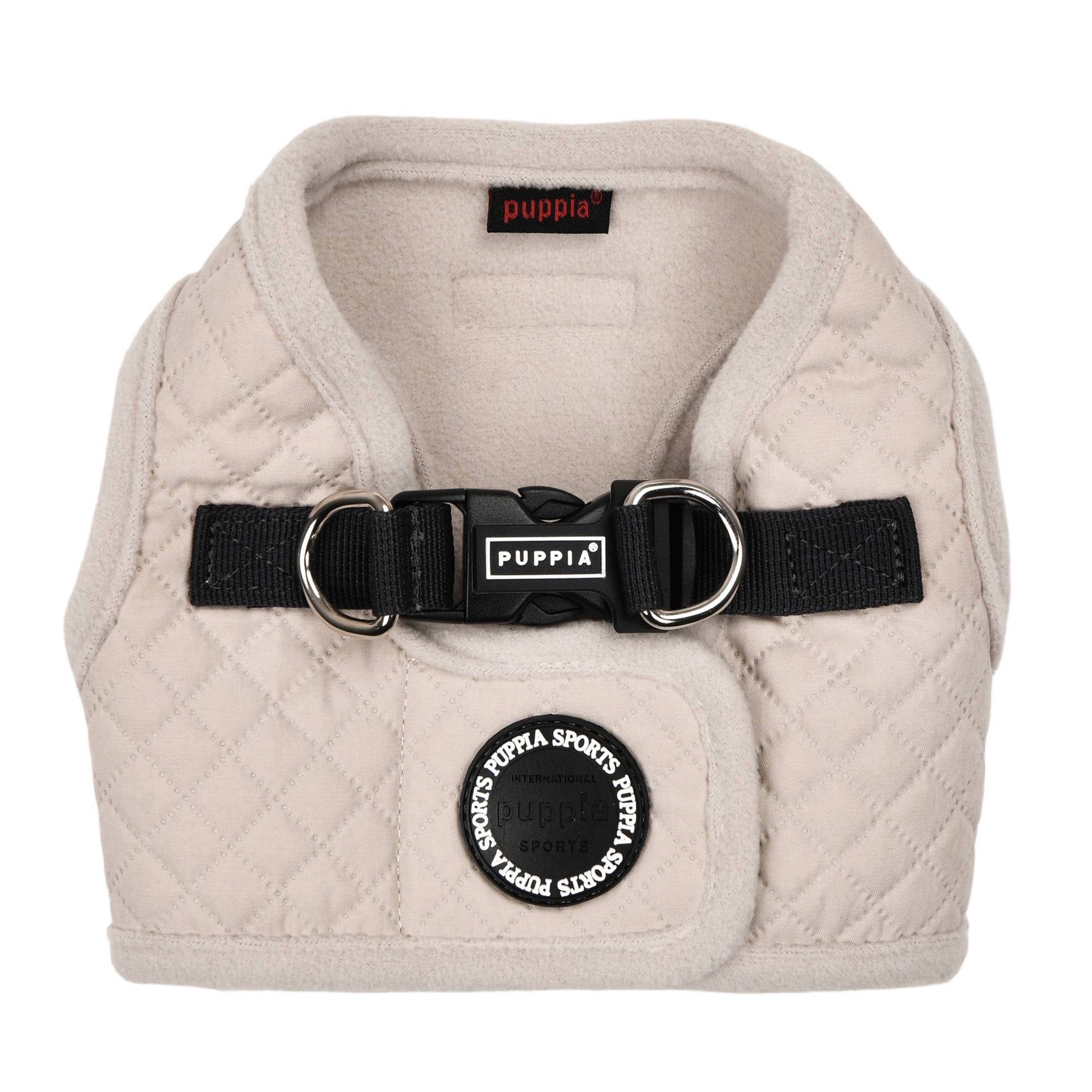 Beige quilted dog harness with black Puppia branding on a white background