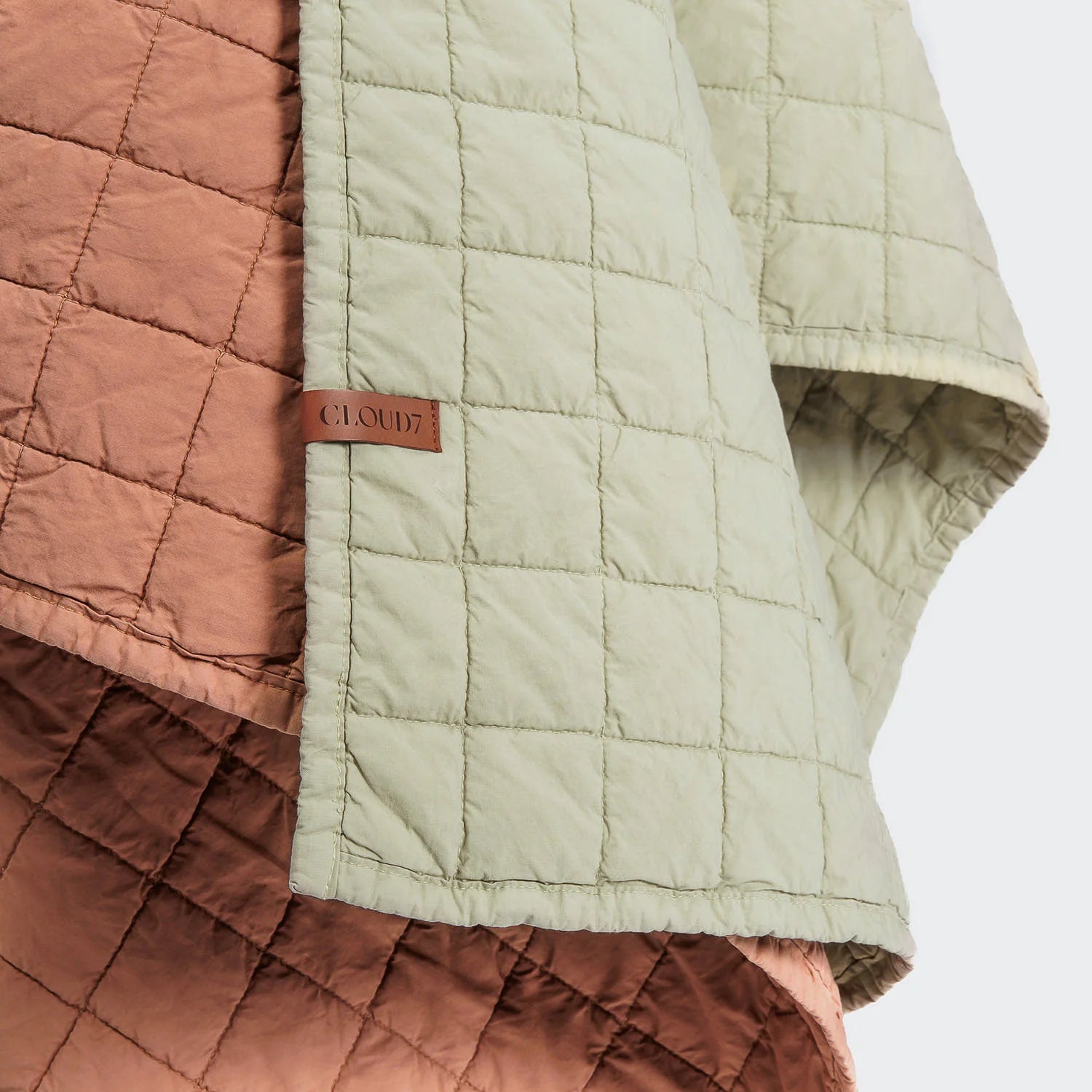 Quilted jacket with brown and green pattern on a white background