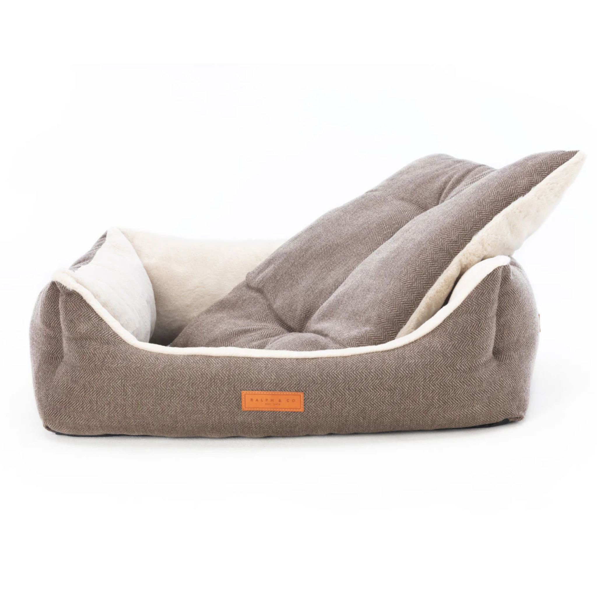 Brown pet bed with white interior on a white background bell & beau 