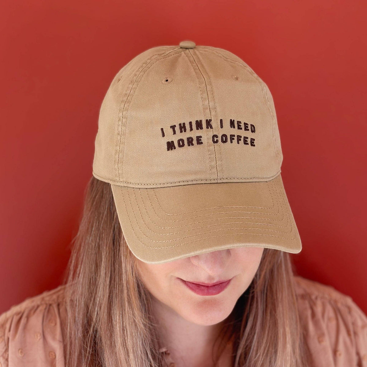 Neutral Sand cotton baseball cap with embroidered coffee slogan.