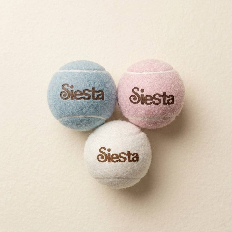 Siesta dog gift set featuring a cotton bandana and three tennis balls.
