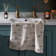 Sophie Allport Doggy Daycare tea towel featuring illustrated dog breeds on a natural stone background.