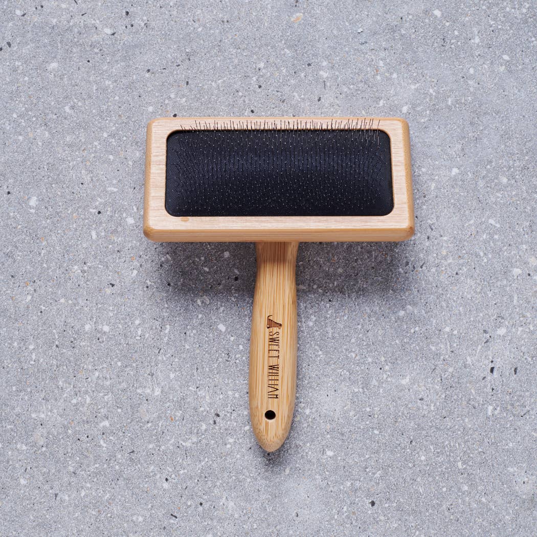 Dog being groomed with the Sweet William Bamboo Slicker Dog Brush