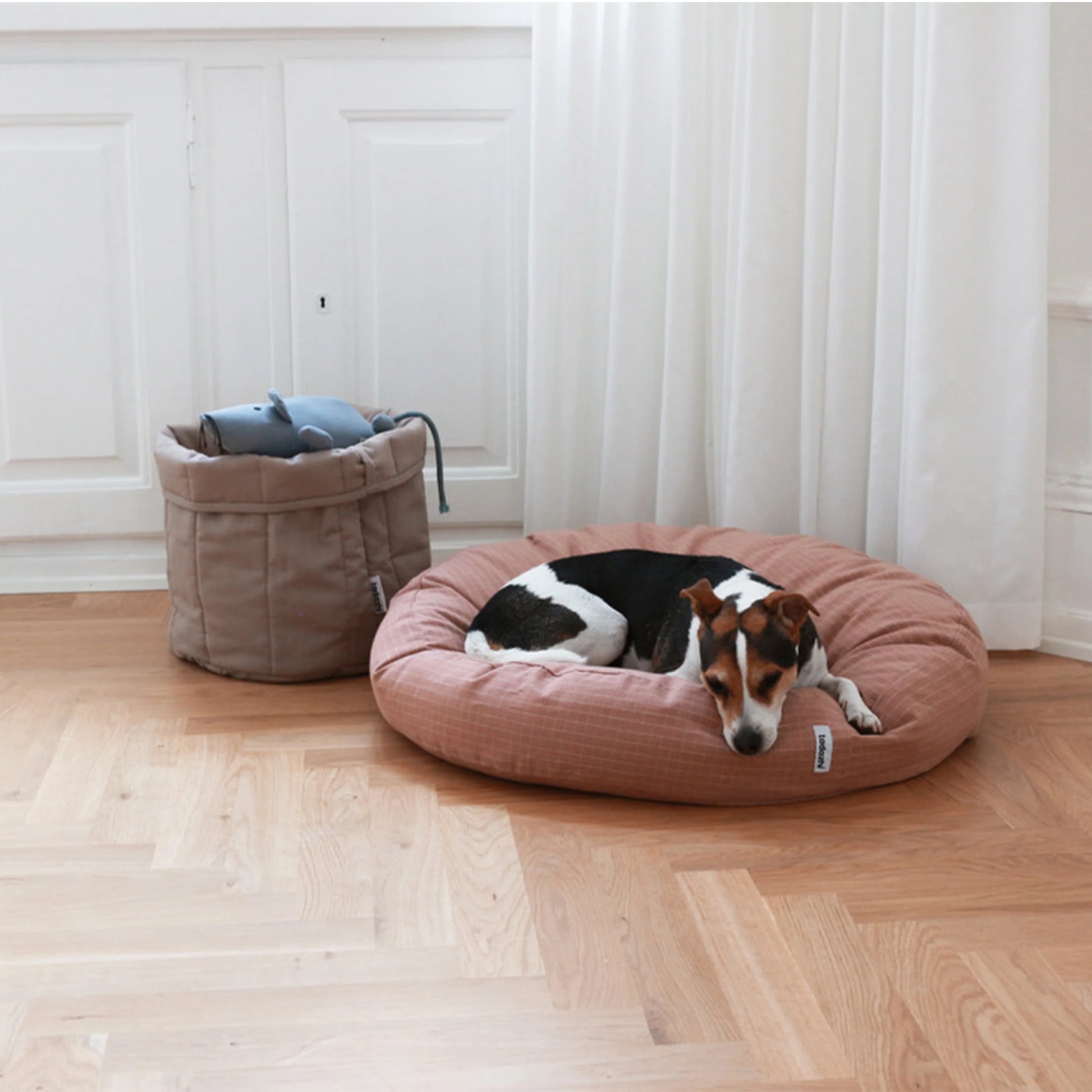 Tadazhi Storage Basket Dark Sand styled in a modern home with dog toys