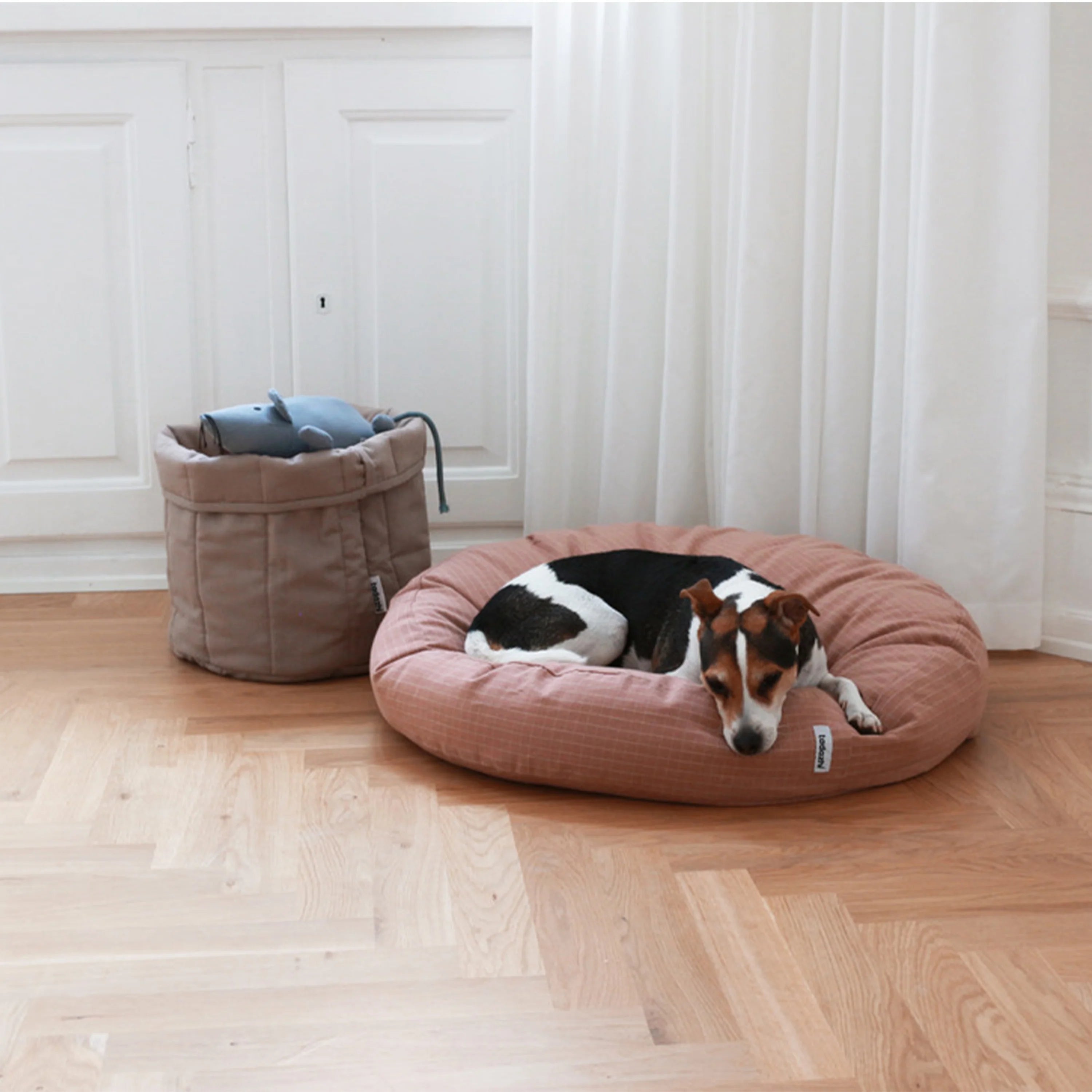 Tadazhi Storage Basket Dark Sand styled in a modern home with dog toys