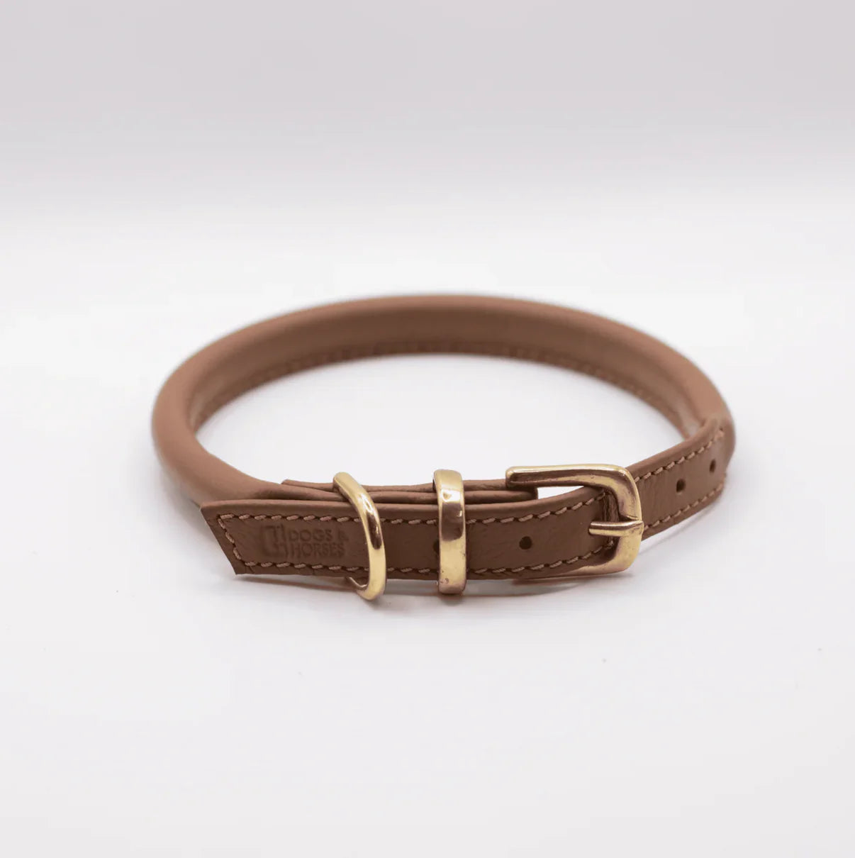 Brown leather dog collar with brass buckle on a white background
