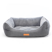 Gray pet bed with a brand label on a white background
