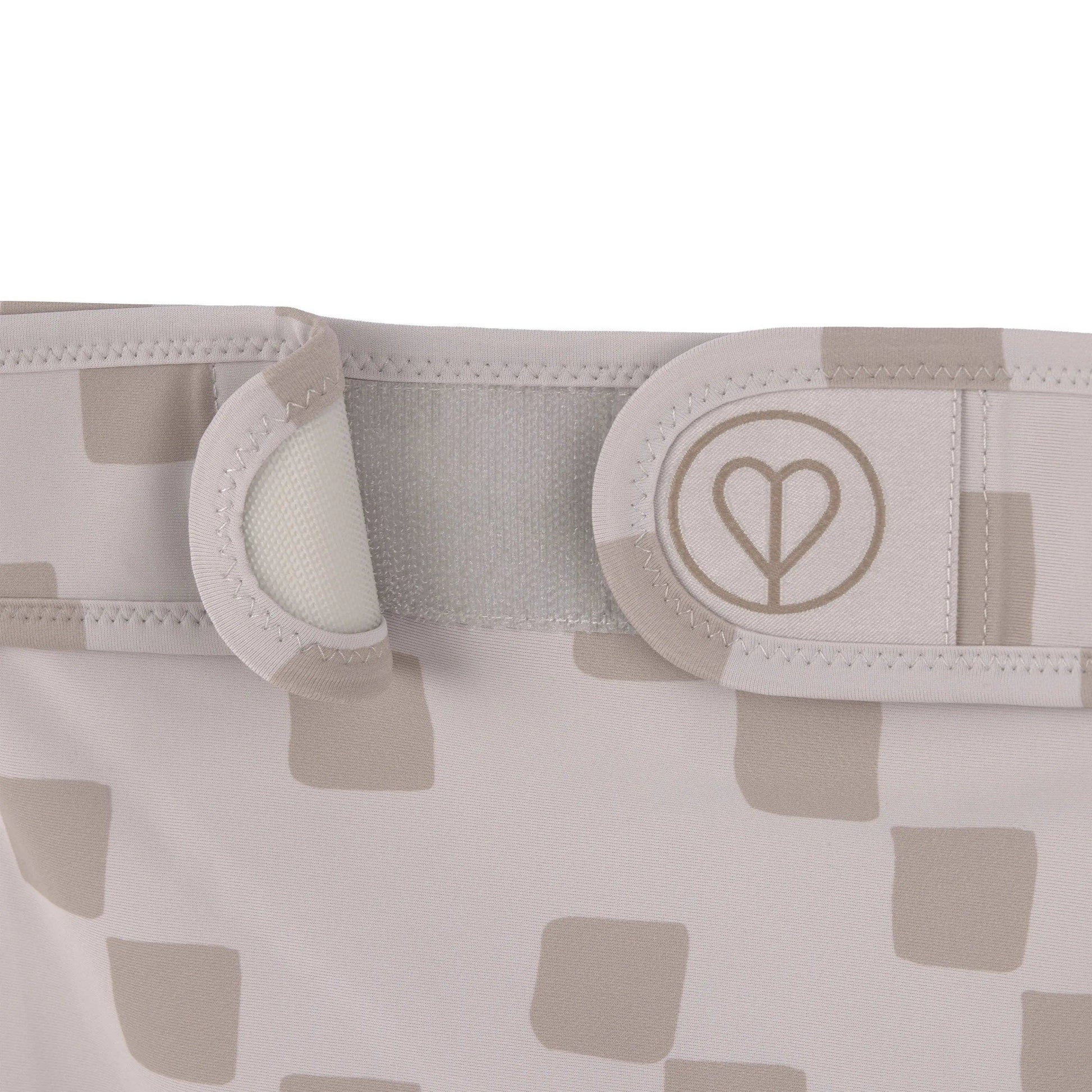 Taupe dog diaper made from recycled materials with soft absorbent lining and comfortable fit.