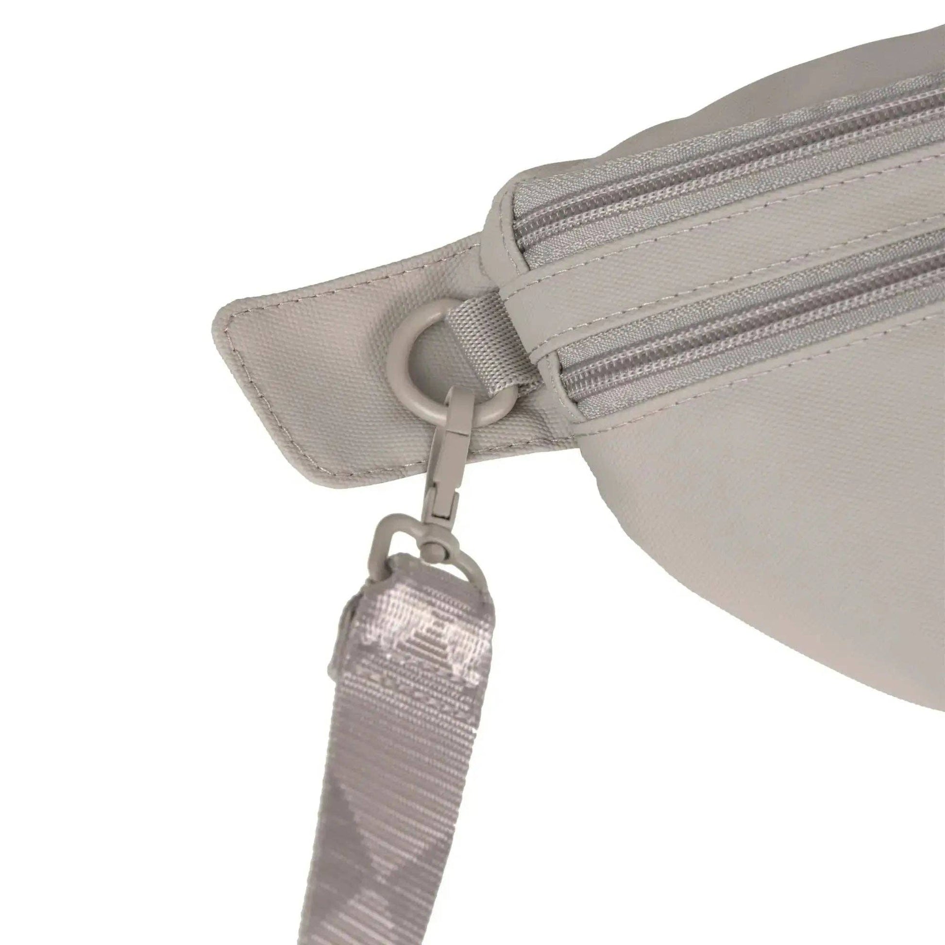 Close-up of a light gray waist bag with a strap on a white background