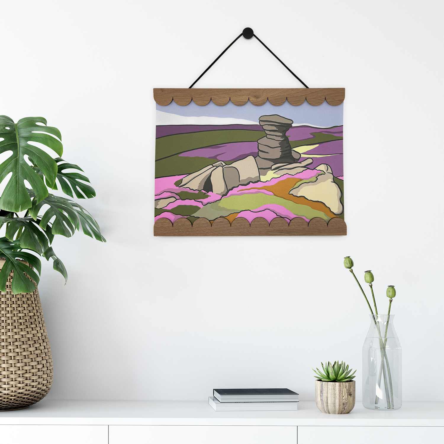 Framed abstract artwork on a wall with decorative elements below