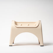 Beige plastic stool on a white background