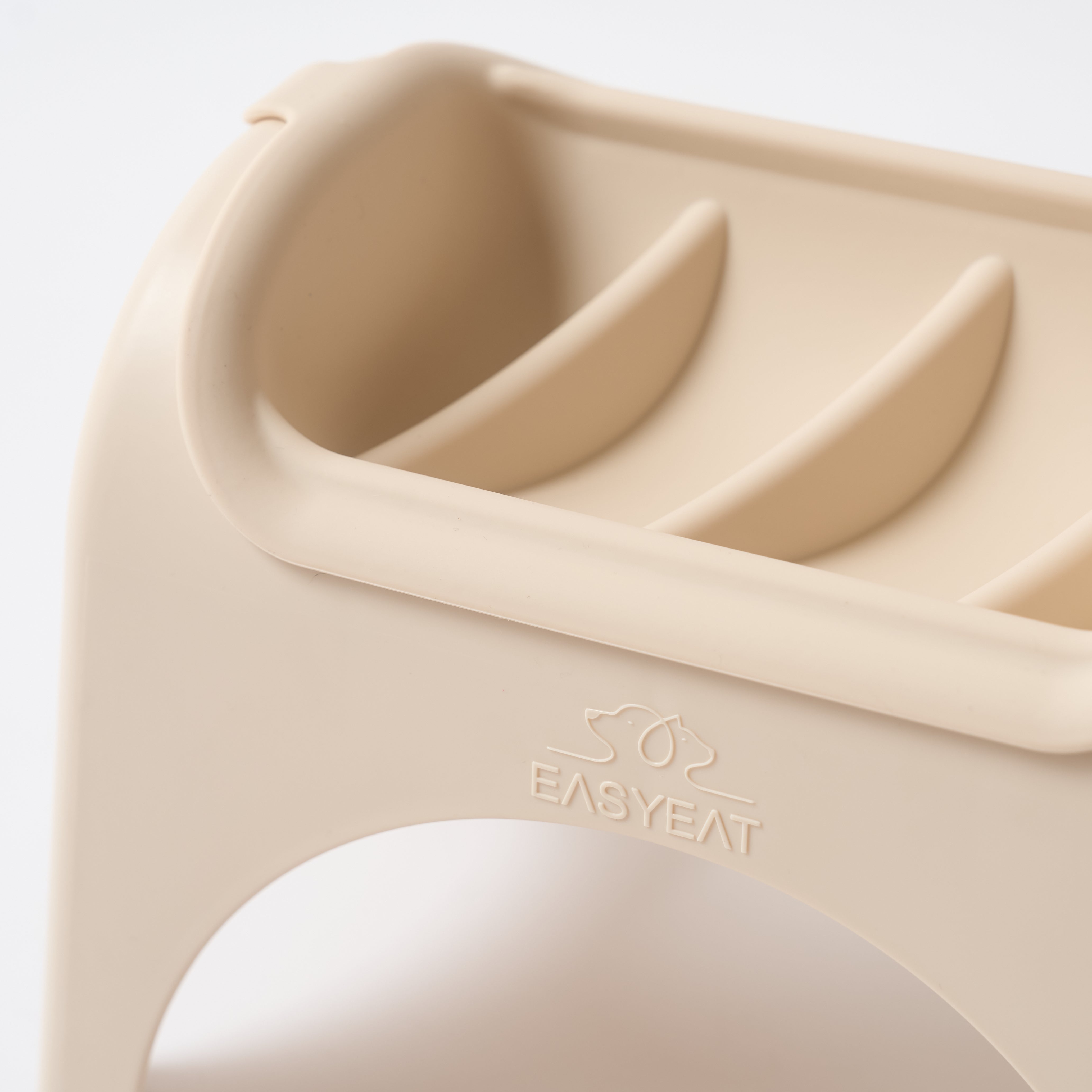 Beige silicone food cutter with 'EASYEAT' branding on a light gray background