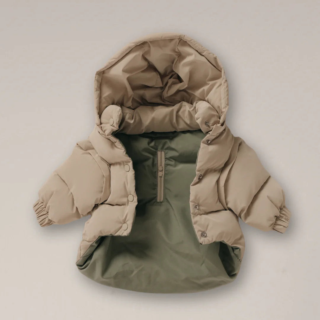 Two-tone puffer jacket with beige hood and green body on a light gray background