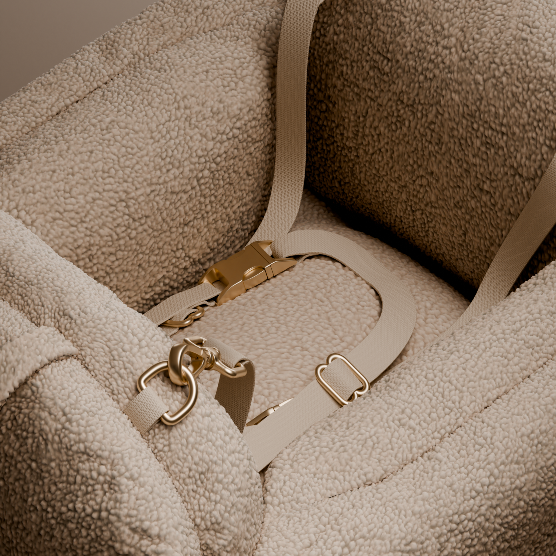 Close-up of a beige textured bag with gold hardware on a matching beige background