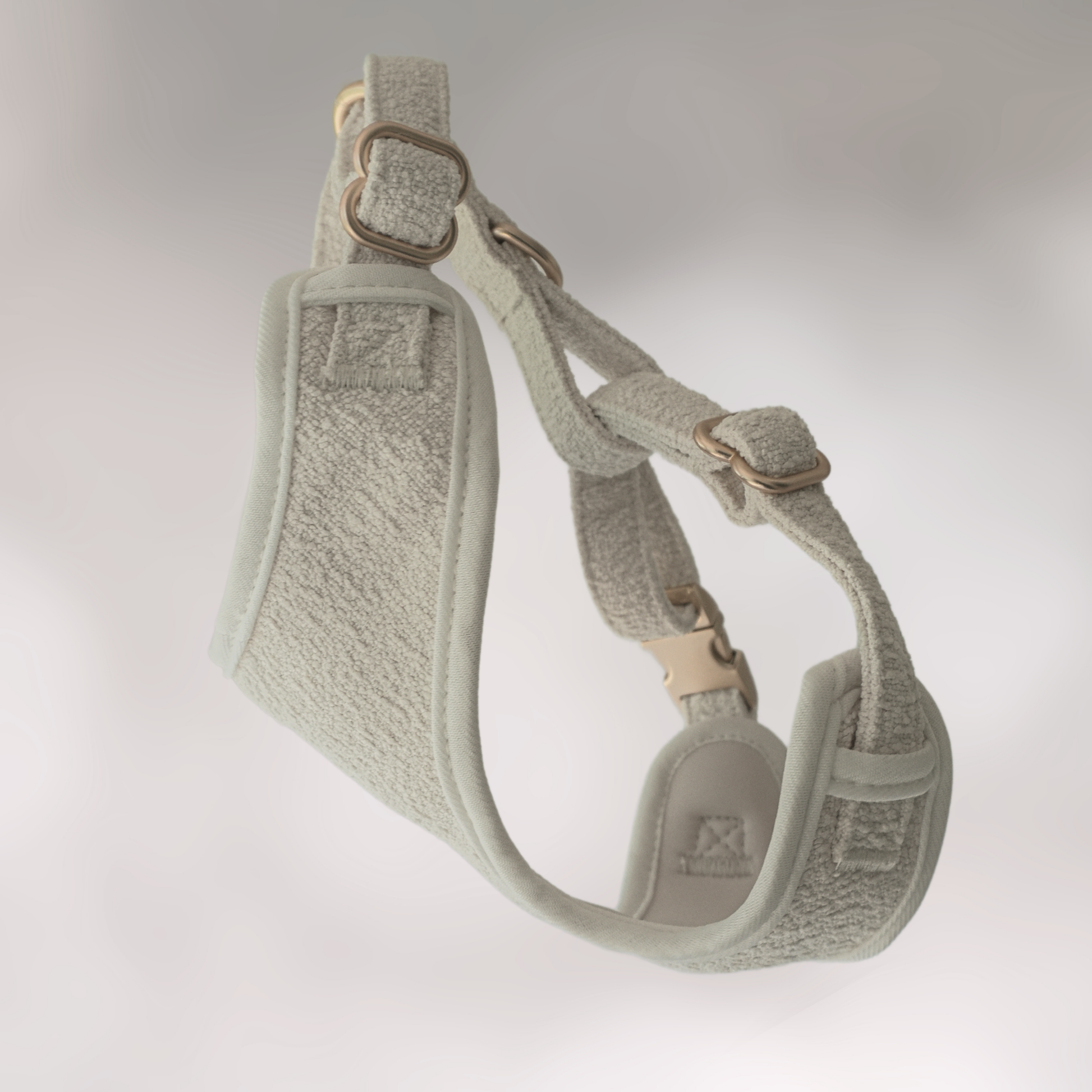 Gray dog harness on a light gray background