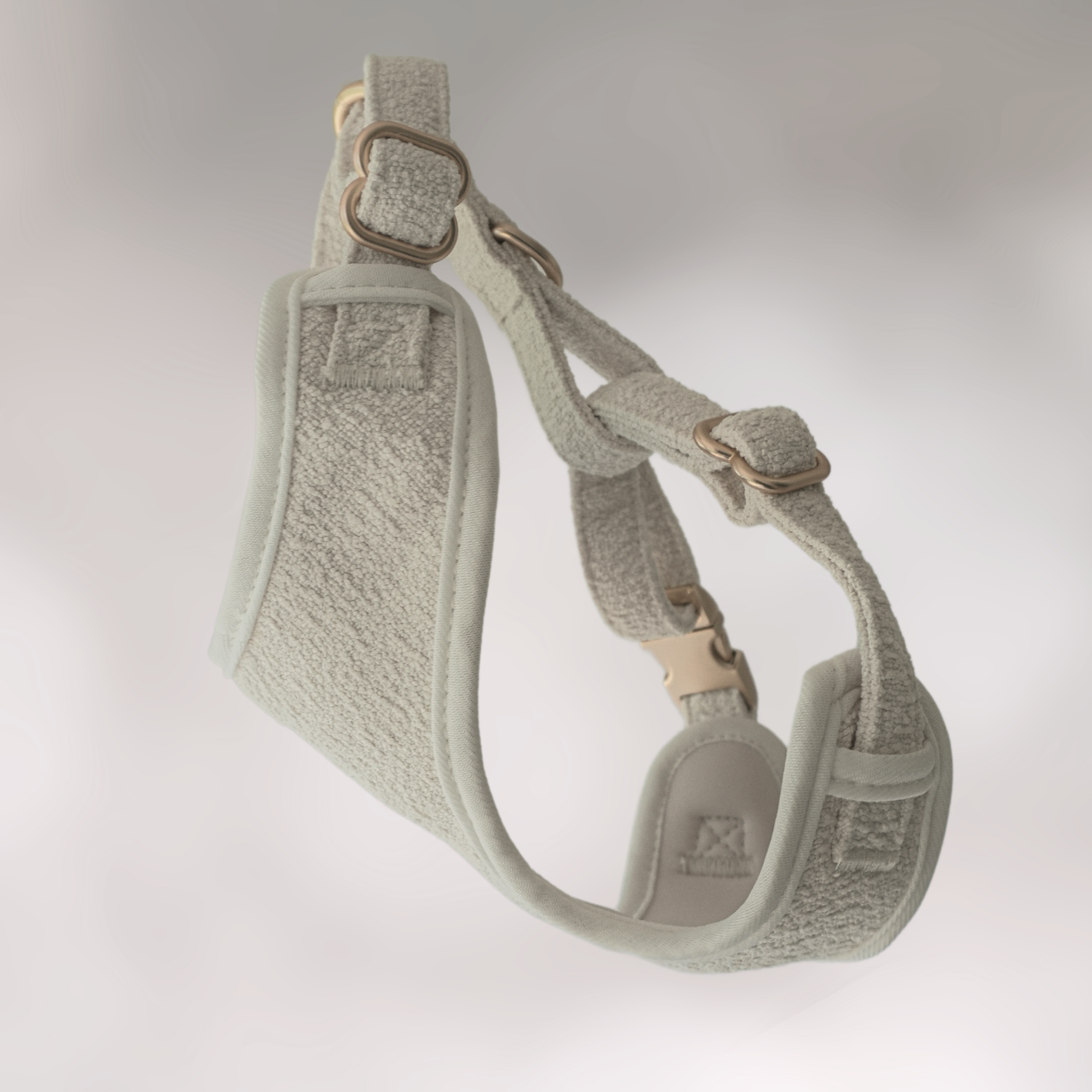 Gray dog harness on a light gray background