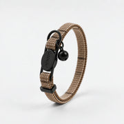 Beige dog collar with black hardware on a white background