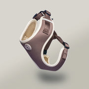 Brown and beige pet harness on a light gray background