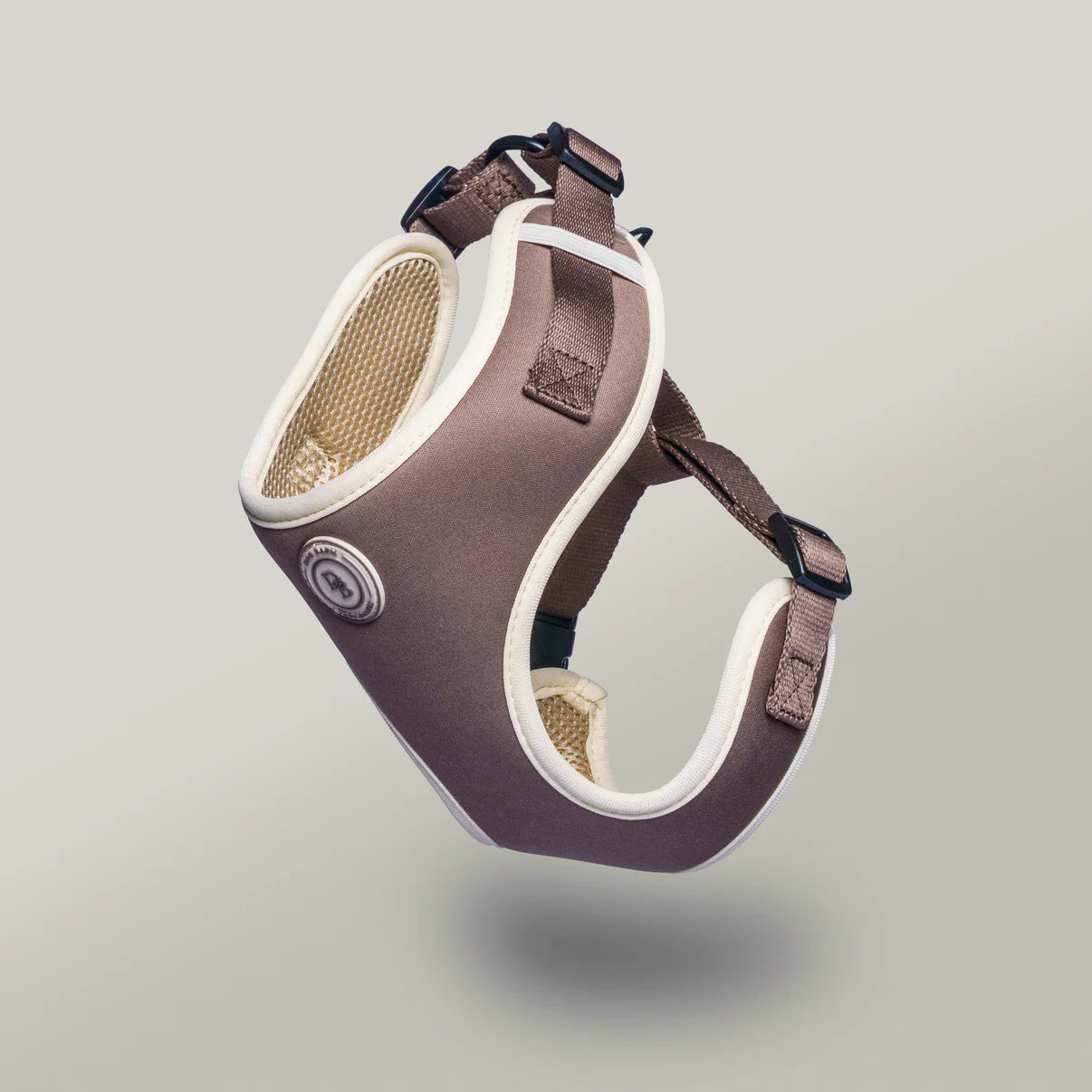 Brown and beige pet harness on a light gray background